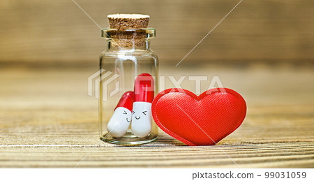 Love medicine. I love you .Tablets in jars are kissing, Happy Valentine's Day, Mother's Day, March 8, World Women's Day holiday card concept. Flat lay. Love medicine. I love you .Tablets in jars are kissing, Happy Valentine's Day, Mother's Day, March 8, World Women's Day holiday card concept. Flat lay. 99031059