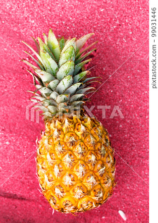 pineapple on pink sand close-up, toned in pink pineapple on pink sand close-up, toned in pink 99031446