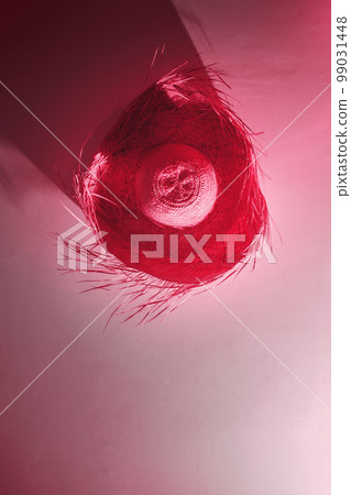 a straw hat on the wall, toned in pink a straw hat on the wall, toned in pink 99031448