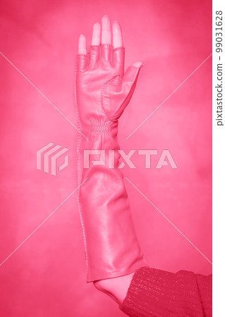 long mitten gloves on a woman's hand, toned in pink long mitten gloves on a woman's hand, toned in pink 99031628
