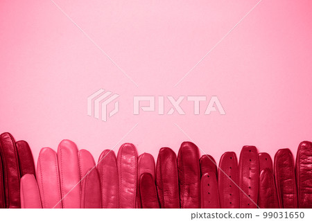 Many gloves on a pink background Many gloves on a pink background 99031650