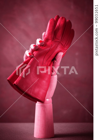 pink gloves in wooden hand, toned in pink pink gloves in wooden hand, toned in pink 99031651