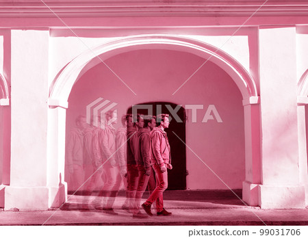 A man is walking, toned in pink A man is walking, toned in pink 99031706