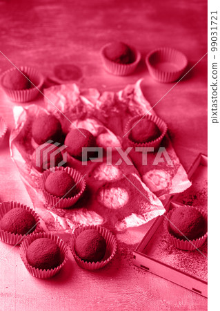 Truffle candies sprinkled with cocoa, toned in pink Truffle candies sprinkled with cocoa, toned in pink 99031721