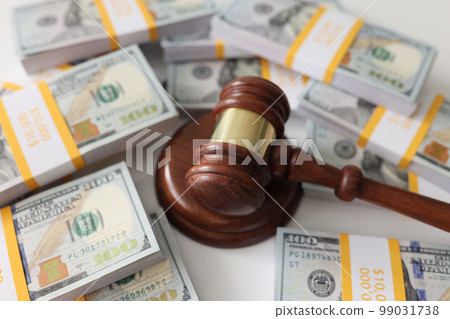Wooden gavel and many us dollar bundles close up. Wooden gavel and many us dollar bundles close up. 99031738