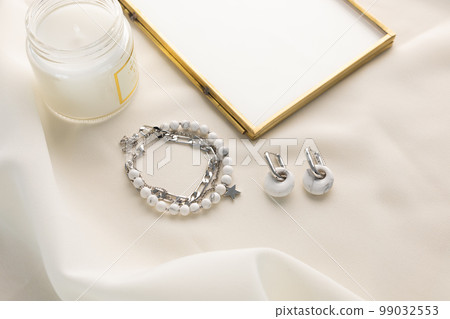 Handmade jewelry on a textile background. Gift for women. Bijouterie and jewellery for women Handmade jewelry on a textile background. Gift for women. Bijouterie and jewellery for women 99032553