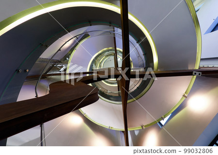Spiral staircase seen from below and with artificial lighting 99032806