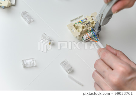 installing a wall ethernet socket. Connecting wires to an socket. installing a wall ethernet socket. Connecting wires to an socket. 99033761