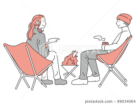 Men and women sitting around a bonfire 99034064