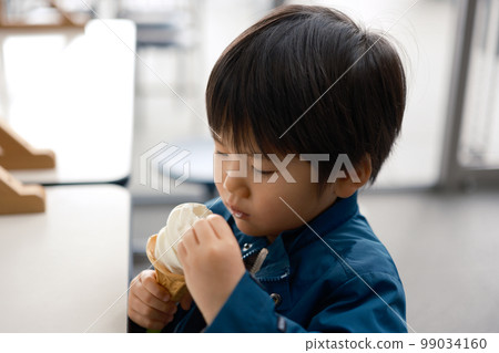 A boy who eats a soft cream A boy who eats a soft cream 99034160