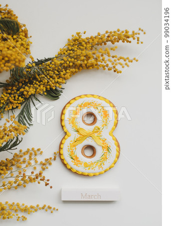 Women's Day, March 8, figure eight, gingerbread, flowers. Space for text. 99034196