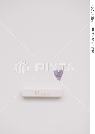 The word March on wooden brick on a white background top view. Hello spring The word March on wooden brick on a white background top view. Hello spring 99034242