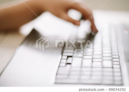 Close-up of male hands typing on laptop keyboard indoors. Businessman working in office or student browsing information. input data for information analysis and sending an email message 99034292
