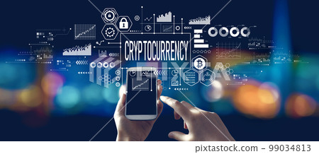 Cryptocurrency theme with person using a smartphone at night 99034813