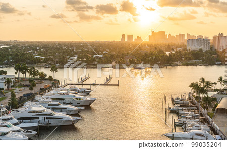 Luxury yacht parked on a canal with the sun coming down at Fort Lauderdale. Port of Fort Lauderdale with Sunset at the marina area 99035204