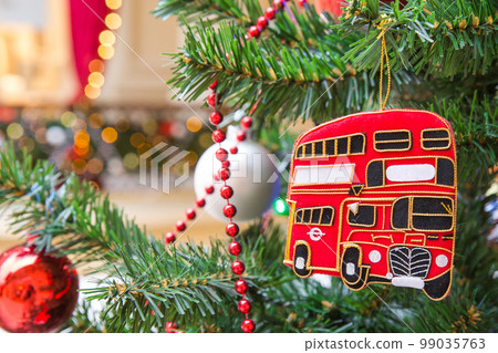 Christmas tree decoration with a red double-decker London bus Christmas tree decoration with a red double-decker London bus 99035763