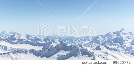White snowy winter Caucasus mountains at sunny day. Panorama view from ski slope Elbrus, Russia 99035772