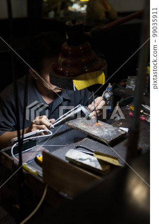 Thai Jeweler making fine Jewelry in a workshop Thai Jeweler making fine Jewelry in a workshop 99035911
