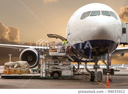 loading cargo into the aircraft before departure with nice sky 99035912