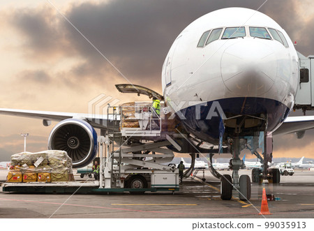 loading cargo into the aircraft before departure with nice sky 99035913