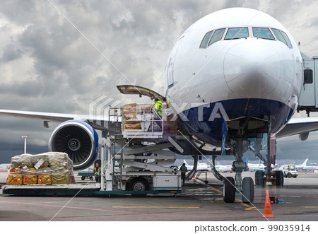 loading cargo into the aircraft before departure with nice sky loading cargo into the aircraft before departure with nice sky 99035914