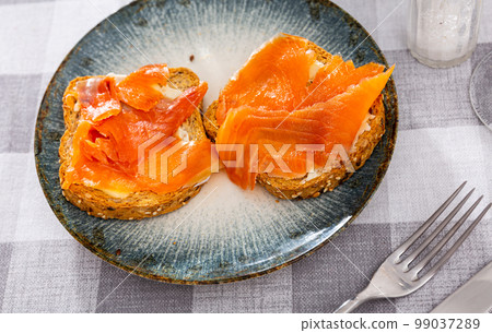 Two sandwiches with white bread butter and smoked salmon Two sandwiches with white bread butter and smoked salmon 99037289