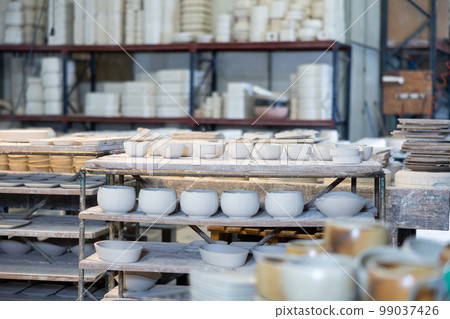 Finished crockery is waiting for painting and drying. Made from white clay 99037426