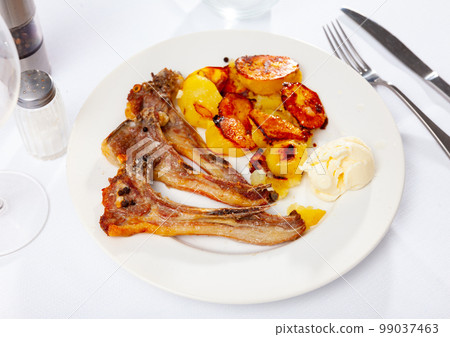 Grilled lamb rib chop steaks, medium rare with french fries on plate Grilled lamb rib chop steaks, medium rare with french fries on plate 99037463