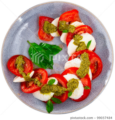 Caprese salad with tomatoes, mozzarella, basil, pesto Caprese salad with tomatoes, mozzarella, basil, pesto 99037484