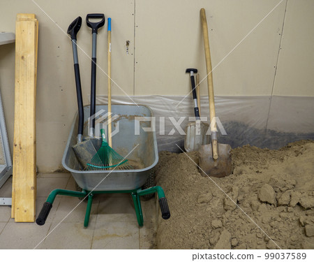 Digging tools. Pile of construction sand Digging tools. Pile of construction sand 99037589