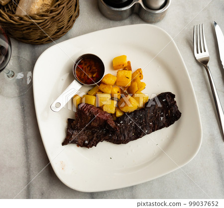 Fried beef fillet with potatoes and sauce Fried beef fillet with potatoes and sauce 99037652