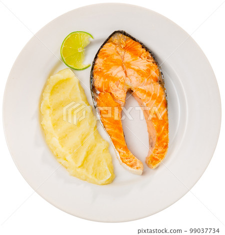 Baked salmon steak and mashed potatoes served with lime 99037734