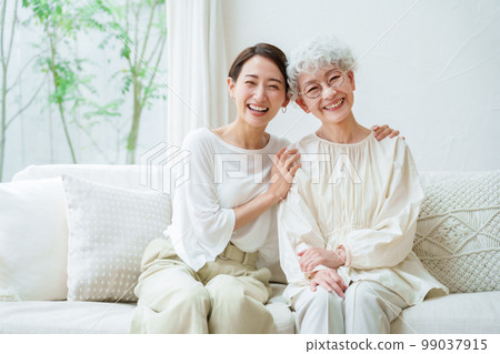 Parent and child relaxing in the living room 99037915