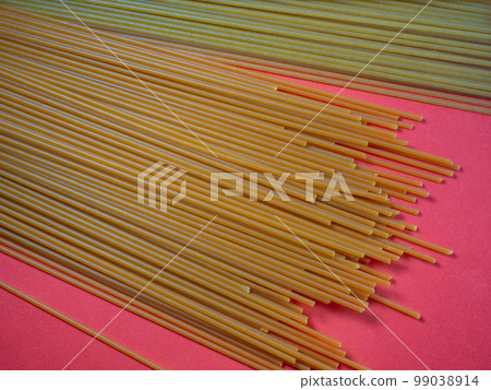 Pasta of two types on the table. Tomato and buckwheat spaghetti. Italian food. Long pasta. Cuisine of the peoples of the world. Cooking food. 99038914