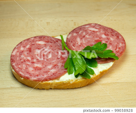 Sandwich with salami, melted cheese and parsley. Homemade food. Food in a hurry. Sandwich with salami, melted cheese and parsley. Homemade food. Food in a hurry. 99038928