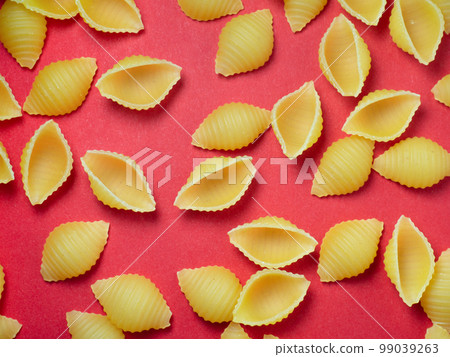 Shell-shaped pasta on the table. Background. Italian food. Cuisine of the peoples of the world. Cooking food. 99039263