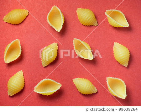 Shell-shaped pasta on the table. Background. Italian food. Cuisine of the peoples of the world.   durum wheat 99039264