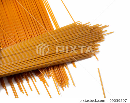Pasta on the table. Spaghetti of two types on a white background. Tomato and buckwheat pasta. Italian food. Cuisine of the peoples of the world. Cooking food. 99039297