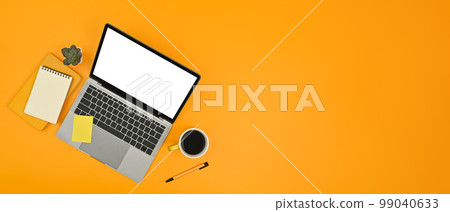 Horizontal image of laptop, notepad and sticky notes on yellow background. Copy space for text information or content 99040633