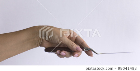 Woman's hand with a palette knife close-up isolated on a white background. 99041488
