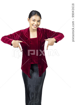 Asian girl wearing red kebaya traditional clothes pointing at something 99041618