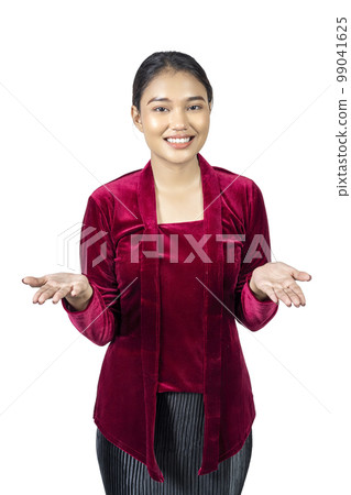 Asian girl wearing red kebaya traditional clothes with open palm hand showing something Asian girl wearing red kebaya traditional clothes with open palm hand showing something 99041625
