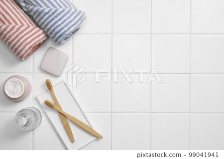 Various bathroom accessories on a tiled background Various bathroom accessories on a tiled background 99041941