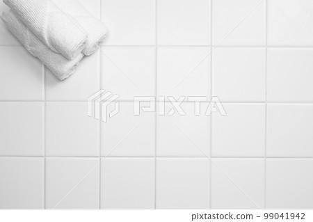Various bathroom accessories on a tiled background Various bathroom accessories on a tiled background 99041942