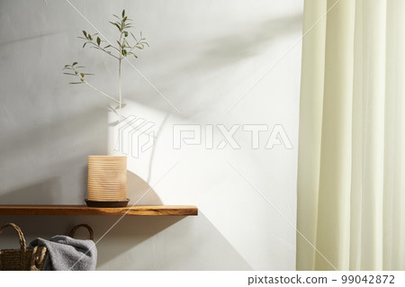 Interior with a beautiful vase in a sunny home Interior with a beautiful vase in a sunny home 99042872