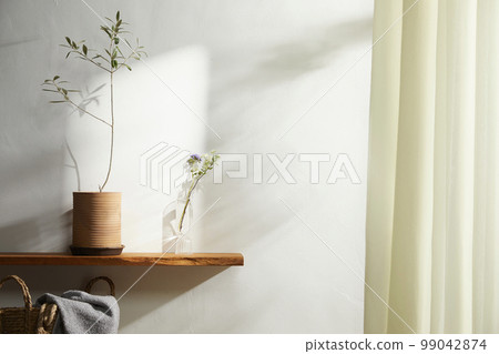 Interior with a beautiful vase in a sunny home Interior with a beautiful vase in a sunny home 99042874