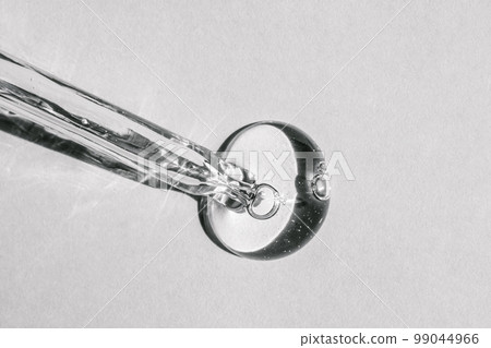 A cosmetic product flows out of a pipette with bubbles. 99044966