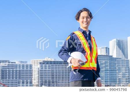 Young security guard guarding the building site Young security guard guarding the building site 99045798