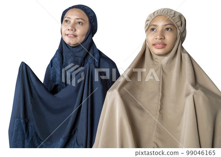 Asian Muslim mother and daughter in a hijab raised hands and praying Asian Muslim mother and daughter in a hijab raised hands and praying 99046165