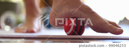 Myofascial relaxation of hypermobile muscles of foot with a massage ball closeup Myofascial relaxation of hypermobile muscles of foot with a massage ball closeup 99046253
